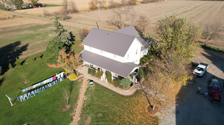white two story house with light grey roofing bourbon in